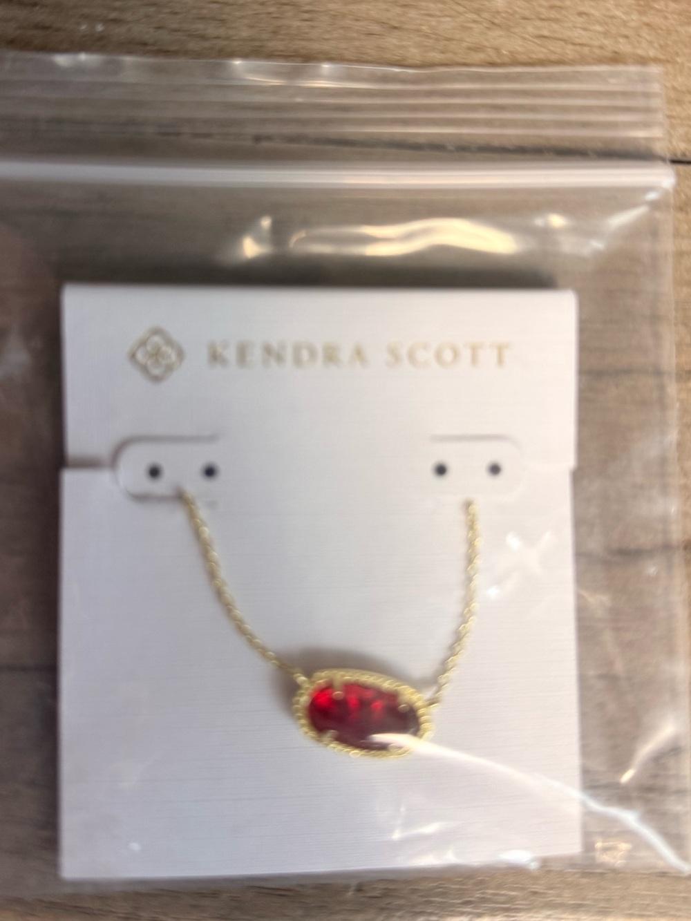 Kendra Scott Gold Necklace with Deep Red Oval Stone